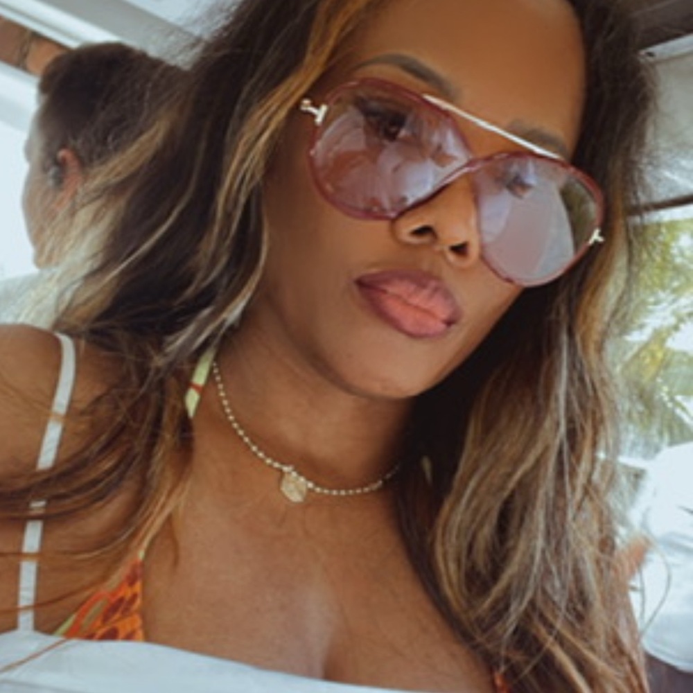Tom Ford large burgundy sunglasses with soft colored lenses and gold hardware.